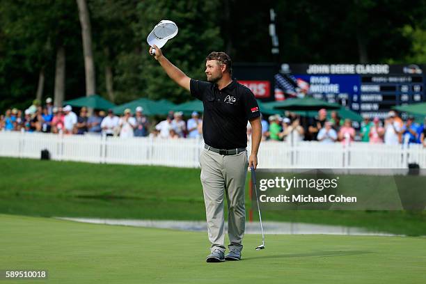 Ryan Moore acknowledges the crowd after his winning putt on the 18th hole during the final round of the John Deere Classic at TPC Deere Run on August...