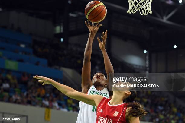 Senegal's power forward Astou Traore and Serbia's forward Sonja Petrovic go for a rebound during a Women's round Group B basketball match between...