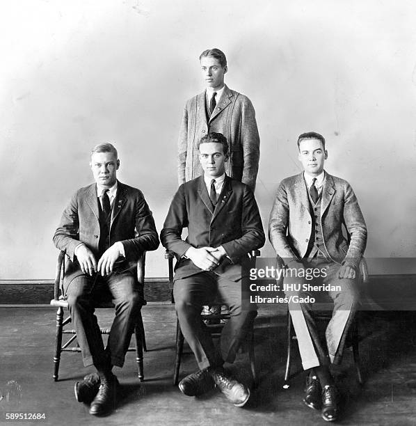 The Freshman Class officers of the Class of 1926 with three men in suits sitting in a row in front of a single man wearing a suit, 1923. .