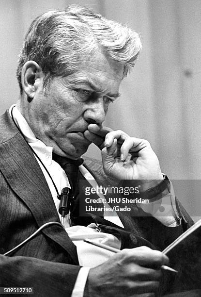 Half body portrait of editor in chief of Time Inc Hedley Donovan concentrating on what he is reading at the American University Symposium, Washington...