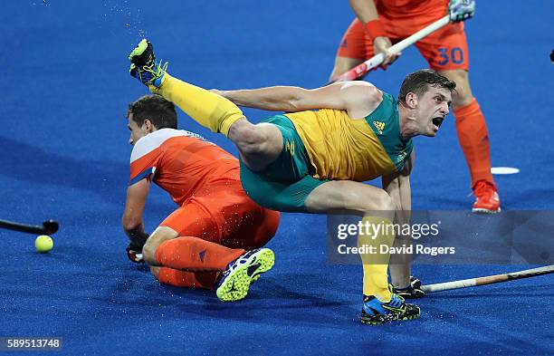 Simon Orchard of Australia is brought down during the Men's hockey quarter final match between the Netherlands and Australia on Day 9 of the Rio 2016...