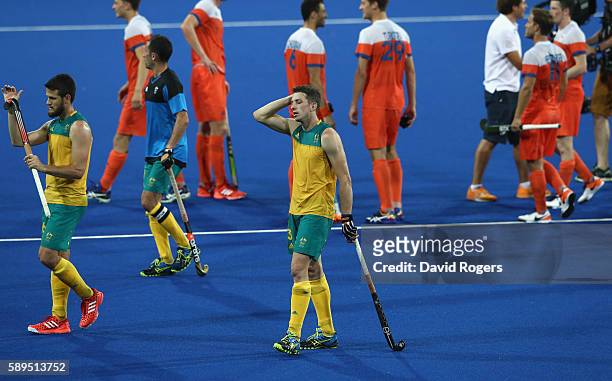 Simon Orchard of Australia looks dejected as he leaves the pitch after Australia's 4-0 defeat during the Men's hockey quarter final match between the...