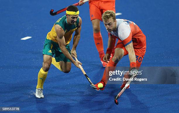 Jamie Dwyer of Australia is challenged by Mink van der Weerden during the Men's hockey quarter final match between the Netherlands and Australia on...