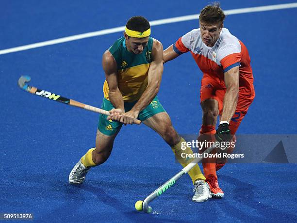 Jamie Dwyer of Australia is challenged by Sander de Wijn during the Men's hockey quarter final match between the Netherlands and Australia on Day 9...