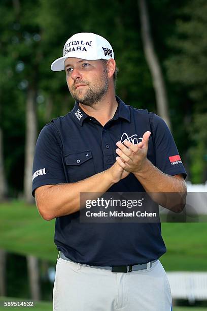 Ryan Moore waits to receive the trophy during the final round of the John Deere Classic at TPC Deere Run on August 14, 2016 in Silvis, Illinois.