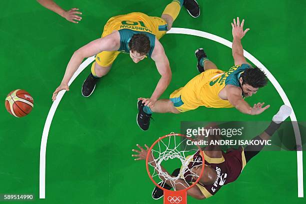 An overview shows Venezuela's point guard Gregory Vargas , Australia's guard Damian Martin and Australia's forward Cameron Bairstow go for a rebound...