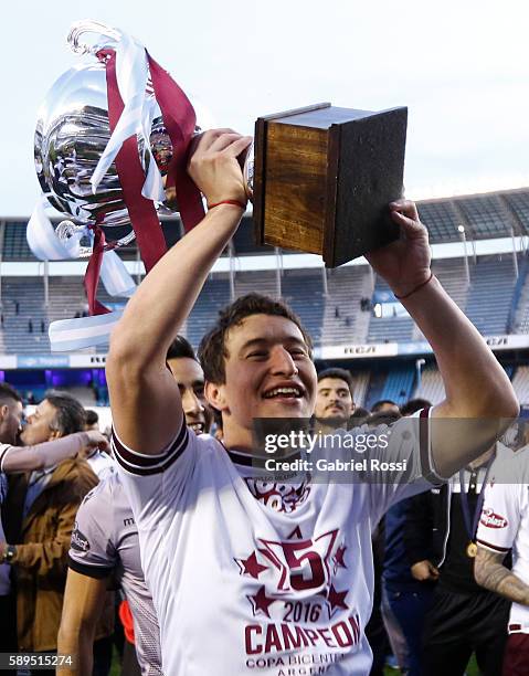 Nicolas Aguirre of Lanus celebrates with the trophy after winning the match between Racing Club and Lanus as part of Copa del Bicentenario de la...