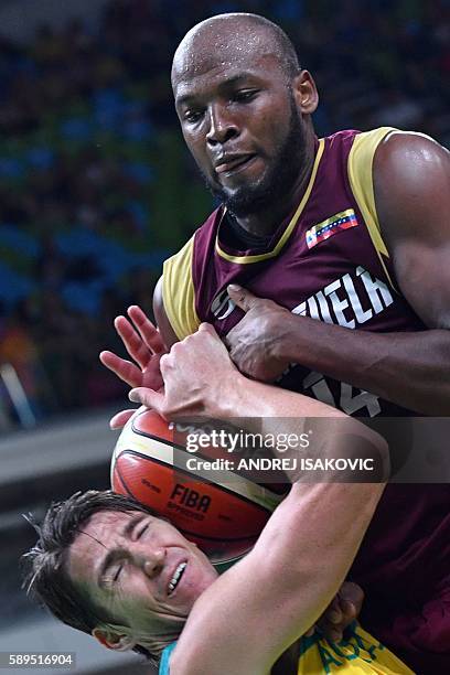 Australia's guard Damian Martin and Venezuela's power forward Miguel Ruiz go for the ball during a Men's round Group A basketball match between...