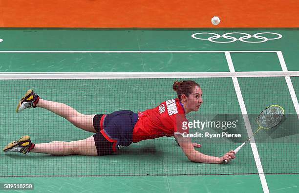 Kirsty Gilmore of Great Britain dives for a shot during her Women's Singles Group match against Linda Zetchiri of Bulgaria during the Table Tennis...