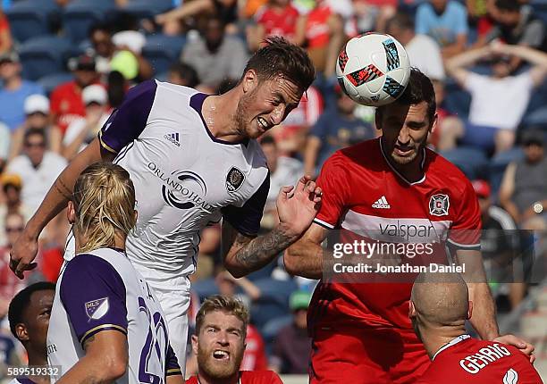 Jose Aja of Orlando City FC heads the ball at the goal past Jonathan Campbell of Chicago Fire during an MLS match at Toyota Park on August 14, 2016...