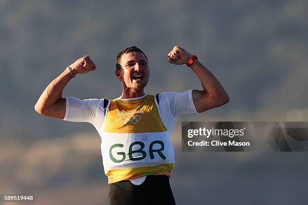 Giles Scott of Great Britain reacts after sealing the gold medal in the Finn class ra on Day 9 of the Rio 2016 Olympic Games at the Marina da Gloria...