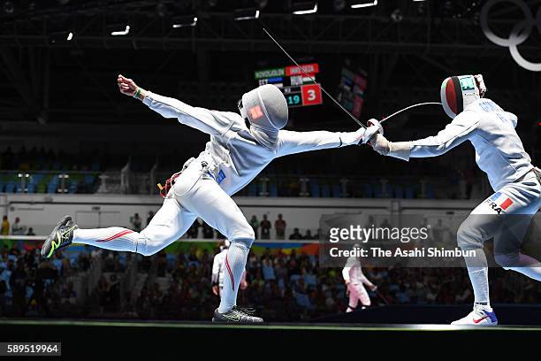 Kazuyasu Minobe of Japan and Gauthier Grumier of France compete in the Men's Epee Individual Quarterfinal on Day 4 of the Rio 2016 Olympic Games on...