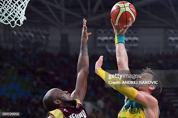 Venezuela's power forward Miguel Ruiz defends against Australia's centre David Andersen during a Men's round Group A basketball match between...