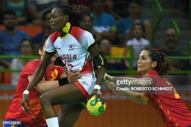 Angola's right back Azenaide Daniela Carlos jumps past Spain's left back Lara Gonzalez Ortega during the women's preliminaries Group A handball match...