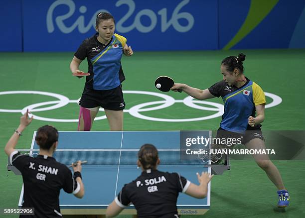 Japan's Ai Fukuhara watches Japan's Mima Ito hit a shot in the women's team semi-final table tennis match against Germany's Shan Xiaona and Germany's...