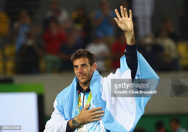 Silver medalist Juan Martin Del Potro of Argentina waves during the medal ceremony for the men's singles on Day 9 of the Rio 2016 Olympic Games at...