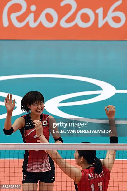 Japan's Saori Kimura and Japan's Erika Araki celebrate during the women's qualifying volleyball match between Japan and Argentina at the...