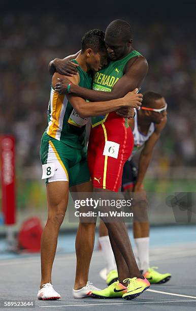 Wayde van Niekerk of South Africa celebrates with Kirani James of Grenada, second place, after winning the Men's 400 meter final on Day 9 of the Rio...
