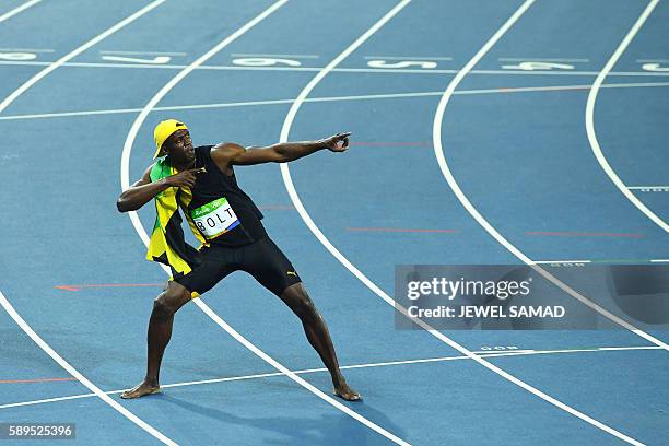 Jamaica's Usain Bolt does his 'Lightening Bolt' pose as he celebrates winning the Men's 100m Final during the athletics event at the Rio 2016 Olympic...