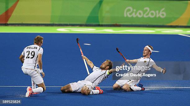 Moritz Furste, of Germany who scored a late equalising goal celebrates with team mates Christopher Ruhr and Niklas Wellen during the Men's hockey...