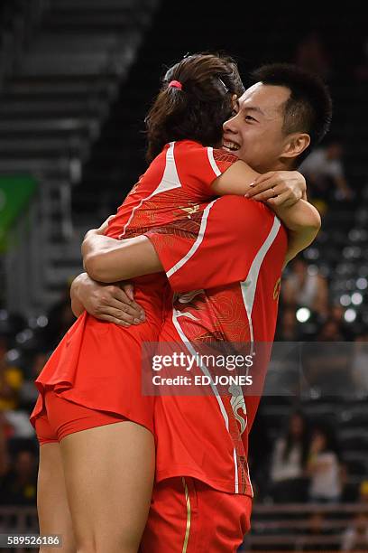 China's Xu Chen and China's Ma Jin celebrate winning against South Korea's Kim Ha Na and South Korea's Ko Sung Hyun during their mixed doubles...