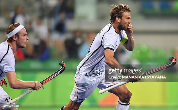 Germany's Moritz Furste celebrates his team's second goal during the men's quarterfinal field hockey Germany vs New Zealand match of the Rio 2016...