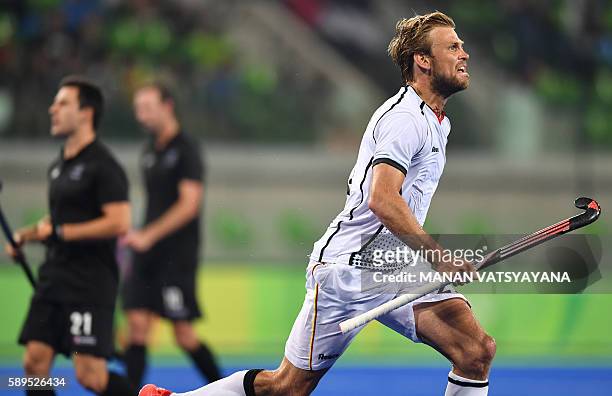 Germany's Moritz Furste celebrates his team's second goal during the men's quarterfinal field hockey Germany vs New Zealand match of the Rio 2016...