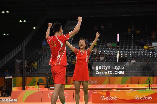 China's Xu Chen and China's Ma Jin celebrate winning against South Korea's Kim Ha Na and South Korea's Ko Sung Hyun during their mixed doubles...