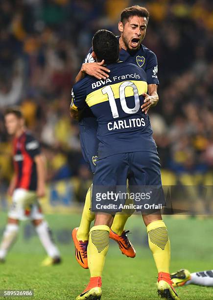 Pablo Perez of Boca Juniors celebrates with teammate Carlos Tevez after scoring the second goal of his team during a friendly match between Boca...