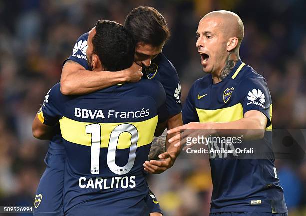 Pablo Perez of Boca Juniors celebrates with teammate Carlos Tevez after scoring the second goal of his team during a friendly match between Boca...