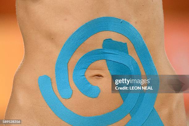 Russia's Evgenia Ukolova wears tape across her stomach area during the women's beach volleyball quarter-final match between Brazil and Russia at the...