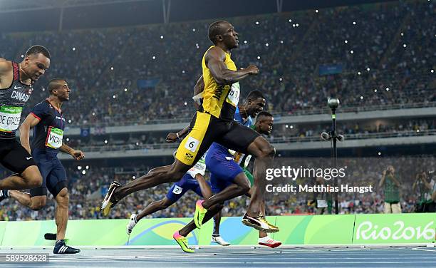 Usain Bolt of Jamaica leads the Men's 100 meter final to win ahead of Justin Gatlin of the United States and Andre De Grasse of Canada on Day 9 of...