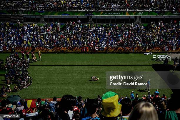 Amy Cragg of the United States falls on her knees after finishing the Women's Marathon on Day 9 of the Rio 2016 Olympic Games at the Sambodromo on...