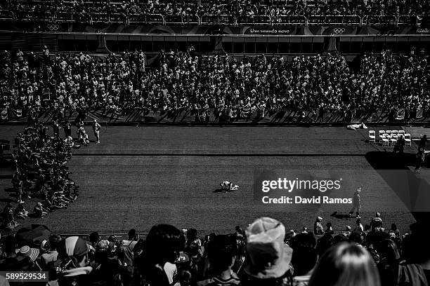 Amy Cragg of the United States falls on her knees after finishing the Women's Marathon on Day 9 of the Rio 2016 Olympic Games at the Sambodromo on...