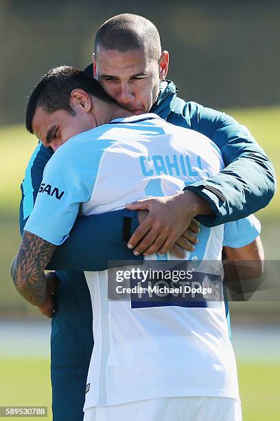 New signing Tim Cahill is hugged by recently retired City Captain Patrick Kisnorbo during a Melbourne City A-League training session at La Trobe...