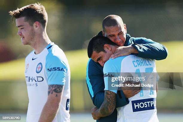 New signing Tim Cahill is hugged by recently retired City Captain Patrick Kisnorbo during a Melbourne City A-League training session at La Trobe...