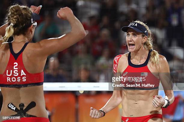 Kerri Walsh Jennings of United States celebrates a point with teammate April Ross during a Women's Quarterfinal match between the United States and...