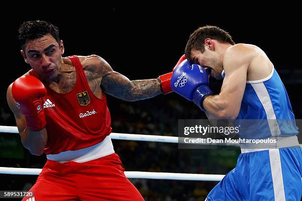 Artem Harutyunyan of Germany and Arthur Biyarslanov of Canada compete in their Light Welterweight 64kg men boxing bout on Day 9 of the Rio 2016...