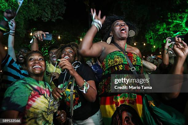 Usain Bolt fans celebrate at the Jamaica House while watching a live broadcast as Jamaica's Usain Bolt wins the 100m final during the Rio 2016...