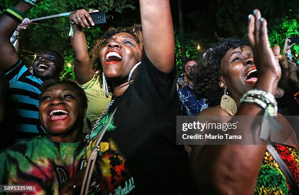 Usain Bolt fans celebrate at the Jamaica House while watching a live broadcast as Jamaica's Usain Bolt wins the 100m final during the Rio 2016...