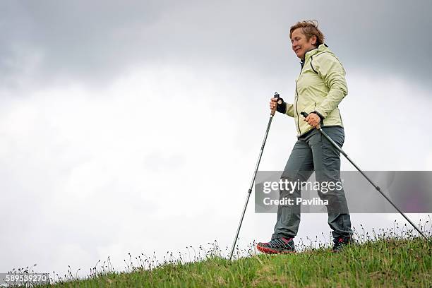 mujer madura nordic walking en plateau, eslovenia, europa - europeo del norte fotografías e imágenes de stock