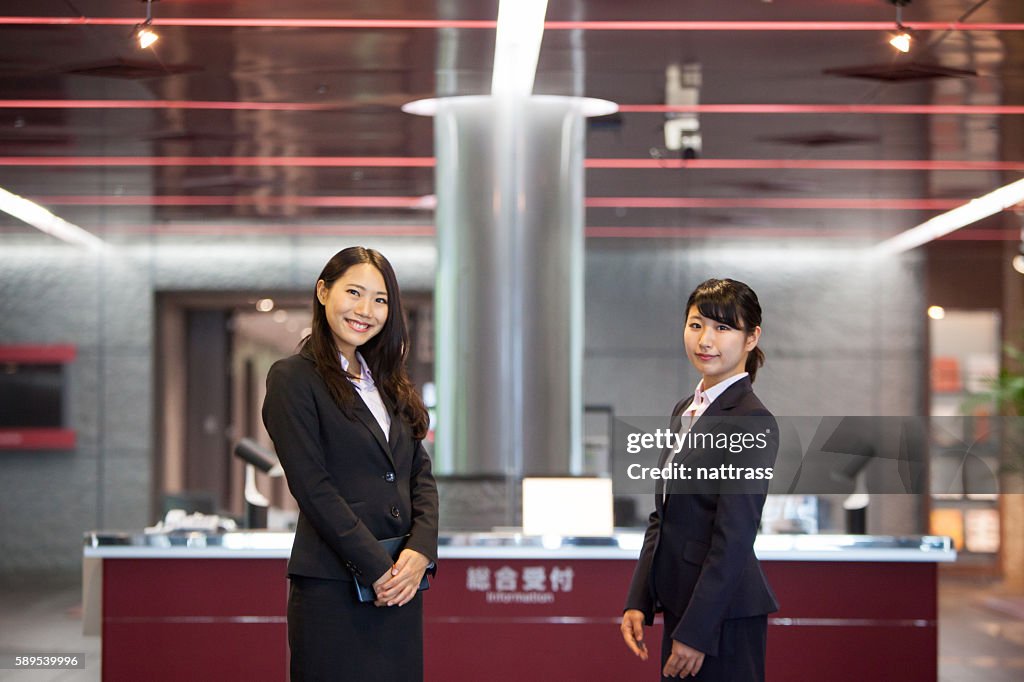 Two Beautiful Japanese women await at reception desk