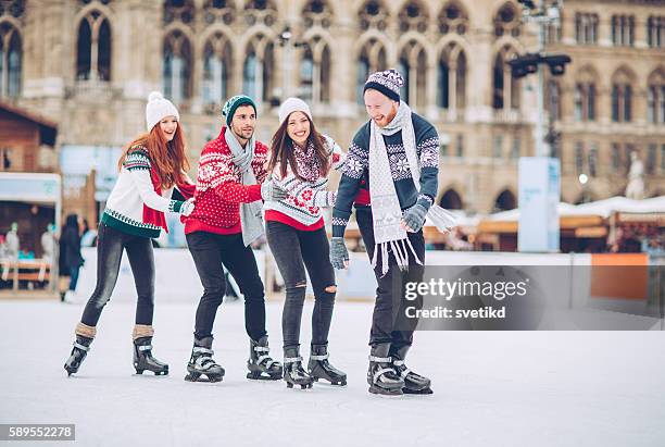 christmas vacation with friends - learning to ice skate stock pictures, royalty-free photos & images