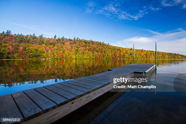 dock on tranquil adirondack lake - adirondack state park stock-fotos und bilder