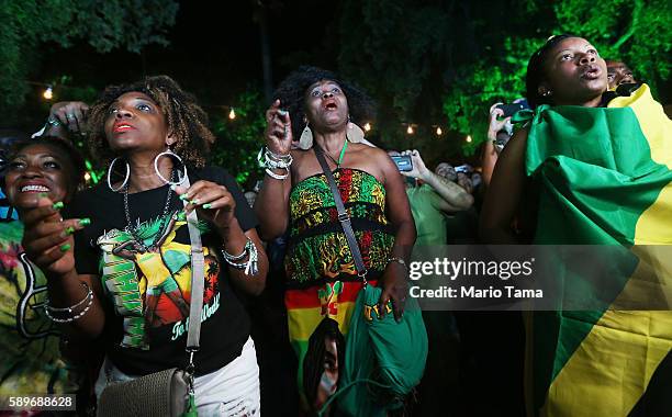 Usain Bolt fans celebrate at the Jamaica House while watching a live broadcast as Jamaica's Usain Bolt wins the 100m final during the Rio 2016...