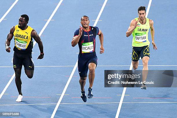 Ashmeade of Jamaica, Jimmy Vicaut of France and Hassan Taftian of Iran competes in the Athletic Men's semifinal of 100m on Day 9 of the Rio 2016...