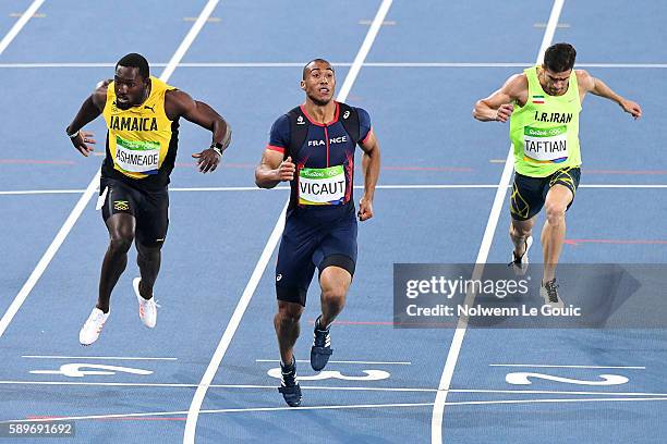 Ashmeade of Jamaica, Jimmy Vicaut of France and Hassan Taftian of Iran competes in the Athletic Men's semifinal of 100m on Day 9 of the Rio 2016...