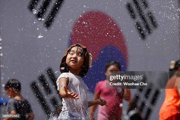 Children play on the ground fountains at Seodaemun Prison, the former prison used to lock Independent fighters from 1908, on August 15, 2016 in...