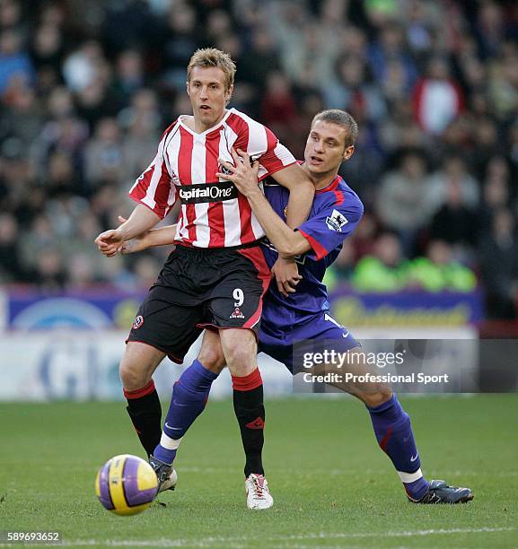 Nemanja Vidic of Manchester United tussles with Rob Hulse of Sheffield United during the Barclays Premiership match between Sheffield United and...