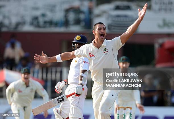 Australia's Mitchell Starc celebrates after he dismissed Sri Lanka's Dilruwan Perera during the third day of the third and final Test cricket match...